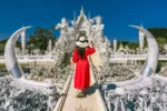 Donna in abito rosso al Tempio Bianco, Wat Rong Khun, Thailandia