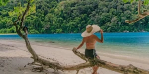 Donna con cappello sulla spiaggia tropicale con mare cristallino in Surin Island