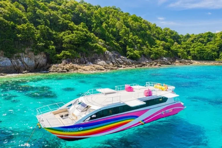 Catamarano colorato in mare cristallino vicino a isola tropicale
